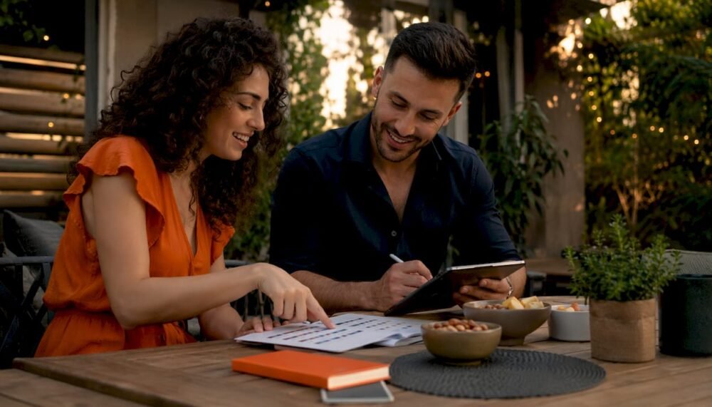 Couple planning wedding song playlist at home